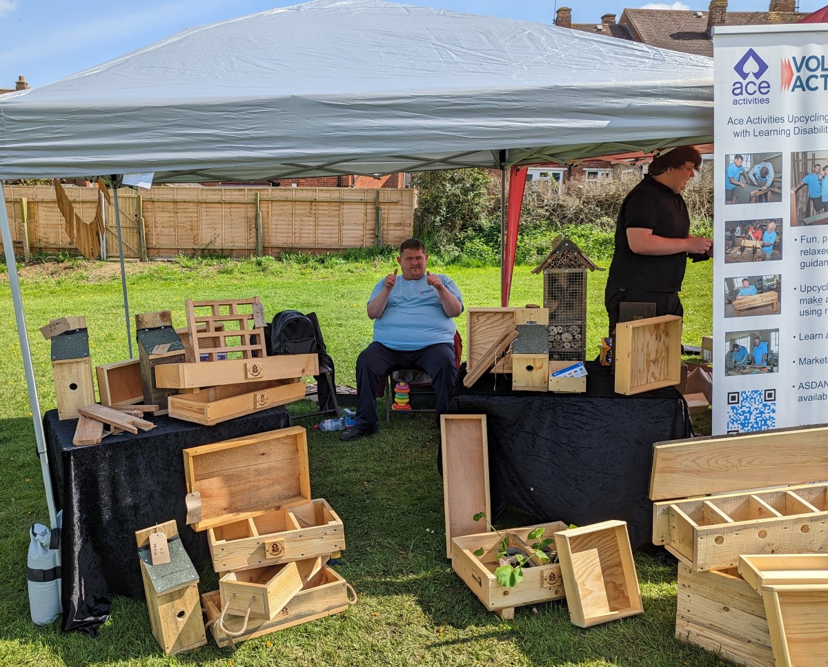 May Fayre 2023 – VAEF 4 A fair stall with various wooden goods including planters, toolboxes, but hotels and bird boxes