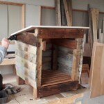 One of the Upcycling team, Aodan, painting a hutch to weatherproof it