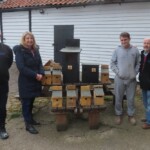 Group photo of the handover of nestboxes to Friends of Swaines Green