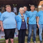 The Epping Mayor, Christine Burgess, stands with the lads from the ACE team in front of the kiosk of wooden products that the Mayor has just declared open.