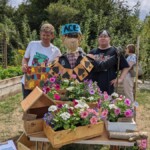 The Upcyclers with planters containing summer bedding flowers