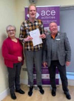 James Penfold receives his certificate from Mayor Christine Burgess and Chair of Grange Farm Trust Trevor Johnson